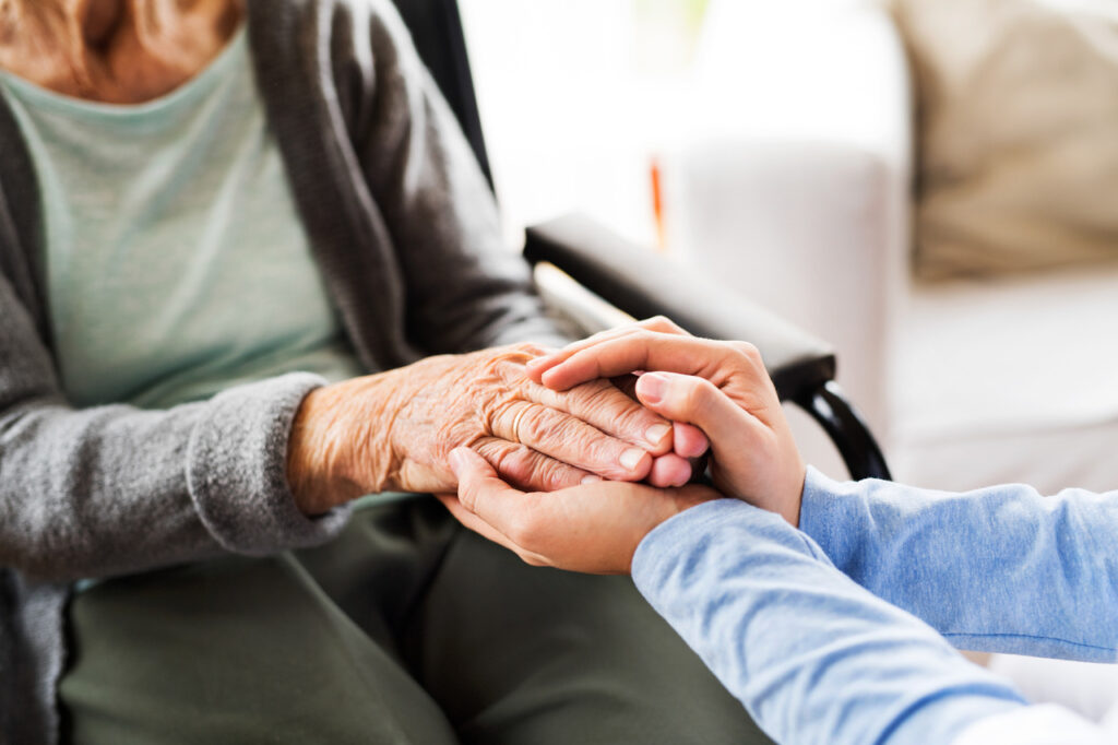 Unrecognizable health visitor and a senior woman during home vis